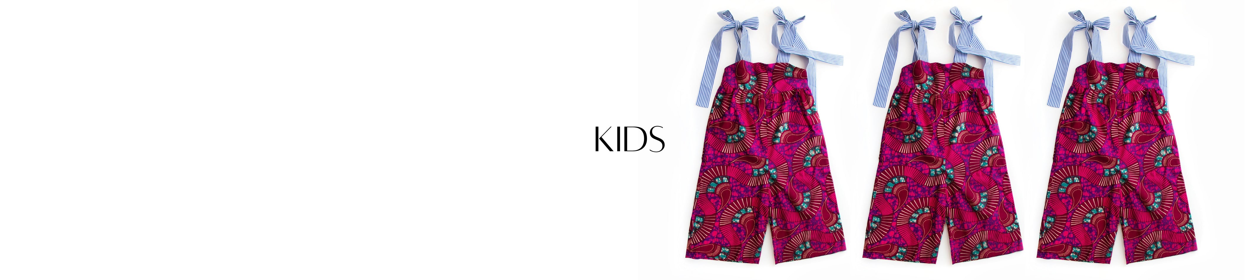 Chen Burkett New York kids jumpsuit in all over magenta and burgundy batik print, featuring blue and white stripe wide shoulders ties.