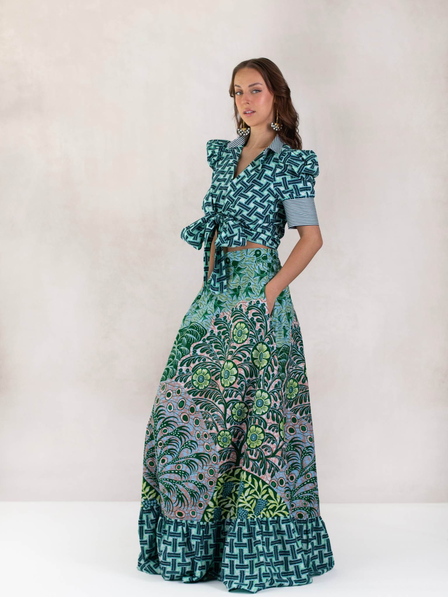Model wears Chen Burkett New York Selah Top and Maxi Skirt in vibrant mixed prints, photographed in studio